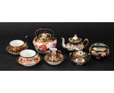 A Royal Crown Derby pattern 2451 miniature tea cup and saucer, another similar, a similar teapot, Crown Staffordshire miniatu