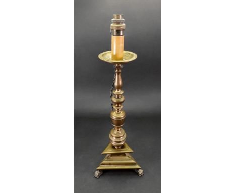 An Italian brass pricket type altar candlestick, in 17th century style, adapted as a table lamp, with a wide circular drip pa