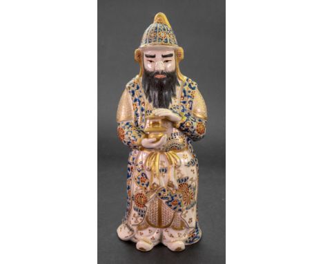 A Japanese Satsuma figure of a soldier, Meiji period, the bearded figure modelled standing wearing a helmet and long robes, h