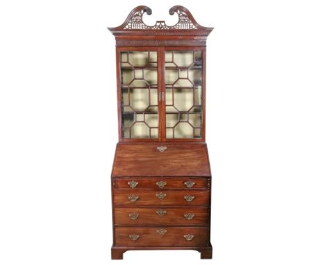 A George III mahogany bureau bookcase, the later fret carved broken swan neck cornice with carved rosettes and Greek key and 