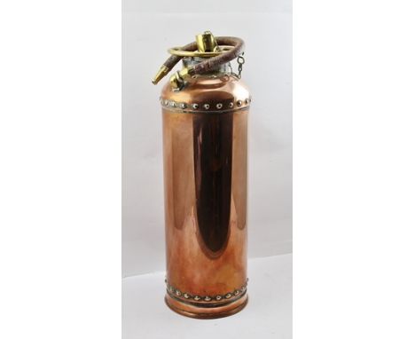 A VINTAGE COPPER FIRE EXTINGUISHER with brass mounts, height 57cm (sold for decorative purposes only) 