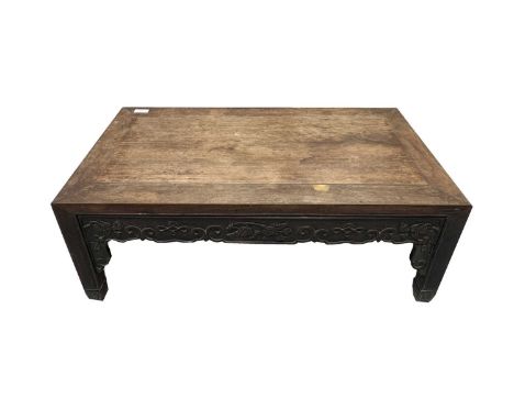 A Chinese hardwood Kang table, 18th/19th century, the rectangular top above a frieze carved with scrolling flowering vines, f