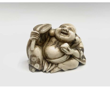 A Japanese ivory netsuke of a seated Hotei holding a uchiwa shaped fan and a peach, early 20th century, height 3.2cm, width 4