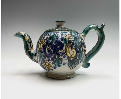 A Moroccan pottery teapot, 19th century, height 12cm, handle to spout 20cm.