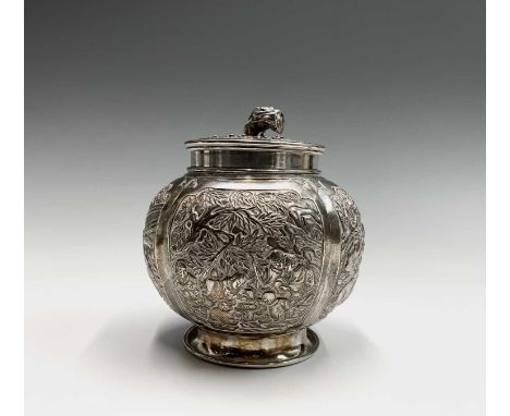 A Chinese silver globular tea caddy, the body with four shaped panels enclosing garden scenes including figures beneath trees