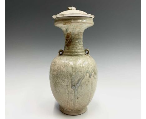 A Chinese pottery vase and cover in Tang style, inspired by a metal prototype, with cupped and ribbed neck, twin shoulder eye