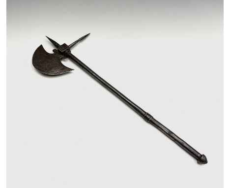 A small Indian axe, the crescent shaped blade with faint traces of decoration, square head with spike on the back and top, de