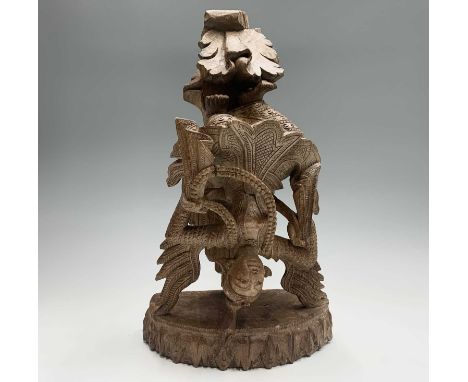 A Burmese carved wood wall bracket, early 20th century, height 50cm, width 29.5cm, depth 14.5cm.