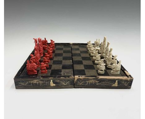 A Chinese Canton carved ivory chess set, 19th century, red stained and natural, kings 7.5 cm high, together with a Chinese bl