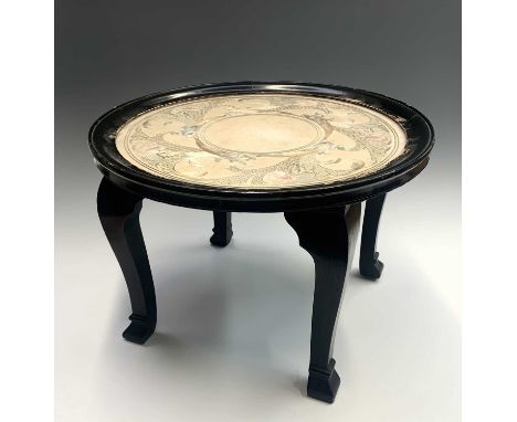 A Chinese ebonised occasional table, circa 1930's, the glazed top above a circular silk embroidered panel decorated with styl