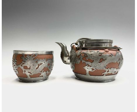 A Chinese Yixing pottery teapot and sugar bowl, early 20th century, with applied pewter mounts and decoration depicting drago