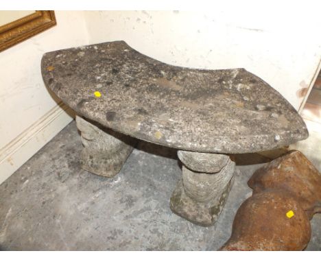 A SMALL STONE GARDEN BENCH