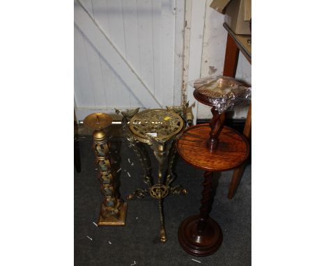 A PIERCED BRASS PLANT STAND, MODERN METAL CANDLE STICK AND AN OAK BARLEYTWIST STAND