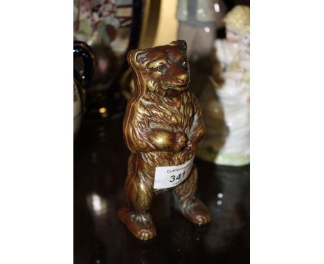 A VINTAGE BRASS BEAR SHAPED MONEY BANK 