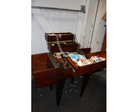 A VINTAGE MAHOGANY TYPE FOLD OUT SEWING BOX AND CONTENTS