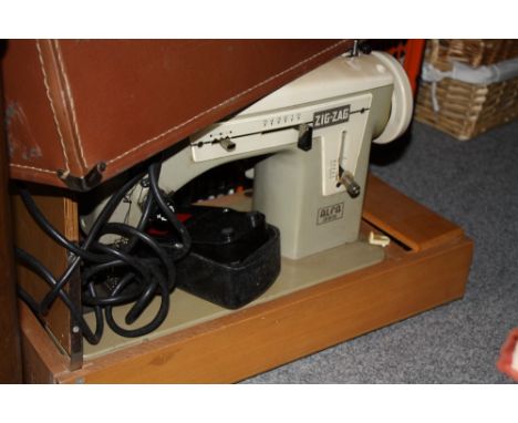A CASED VINTAGE ALPHA 365 ZIG ZAG SEWING MACHINE