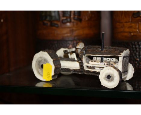 AN UNUSUAL CARVED HORN MODEL OF A TRACTOR 