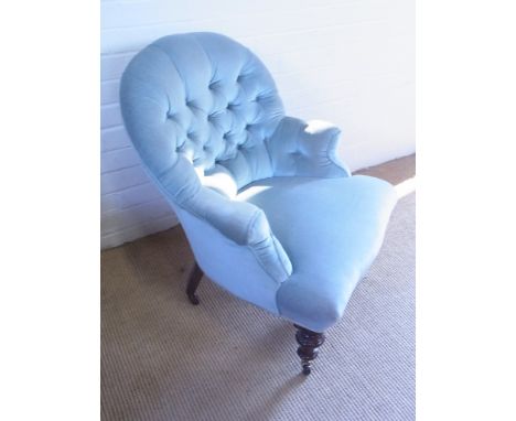 A Victorian upholstered button back fireside chair