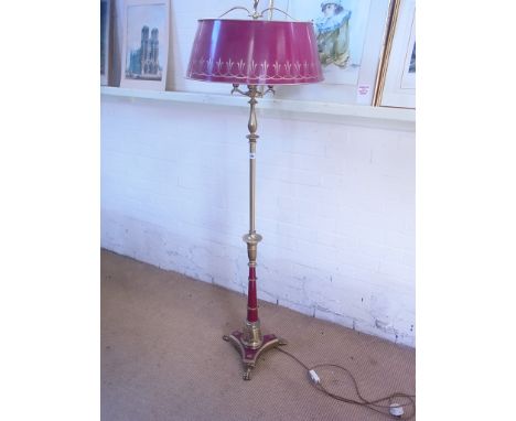 An ornate brass and maroon decorated standard lamp with metal shade on triform base - Height 169cm