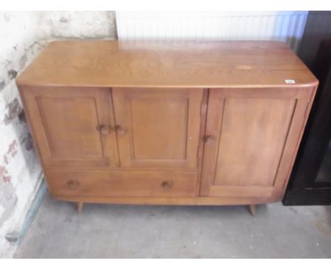 An Ercol golden elm sideboard of three doors and single drawer - Height 82cm x 114cm x 50cm