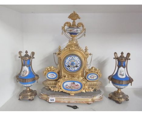 A French ormolu and porcelain mantle clock with two associated garnitures, the Japy Freres movement striking on a bell ,back 