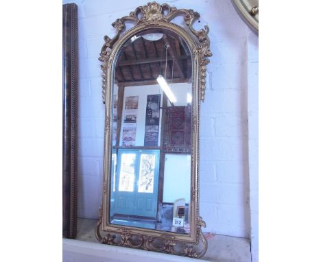 An ornate modern gilt mirror - 82cm x 38cm