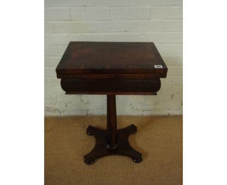 A 19th century rosewood games table with a foldover top with cribbage, chess and backgammon board on a tapering octagonal col