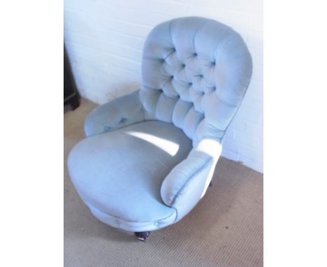 A Victorian upholstered button back fireside chair