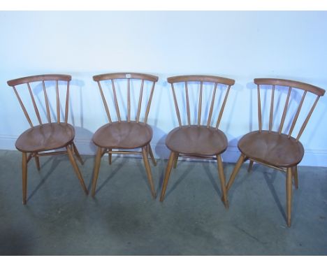 Four Ercol golden elm dining chairs