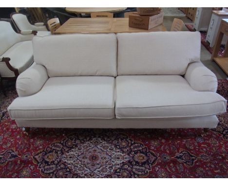 A two seater sofa in an oatmeal fabric - Width 2m x Depth 96cm x Height 90cm - only two years old