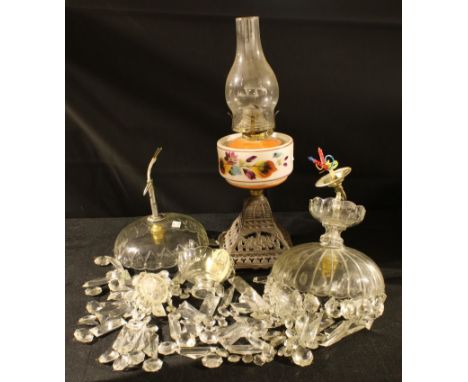 An early 20th century cast iron oil lamp, opaque glass reservoir, painted with foliage, 47cm high;  two clear glass ceiling l