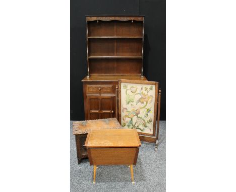 An oak dresser, two drawers over two panelled cupboard doors to base, 178cm high, 94cm wide; a carved oak chest of small prop