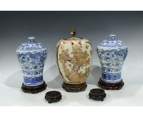 A pair of Chinese blue and white vases with hardwood stands; a Chinese Satsuma type lamp on hardwood stands; a pair of hardwo