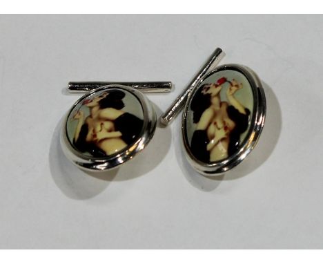 A pair of silver and enamel novelty risque cufflinks, each decorated in polychrome with a scantily clad lady with a rose, 2cm