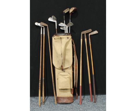 Sporting Interest - a mid 20th century canvas and leather golf bag containing 14 vintage clubsGolf bag and 14 vintage clubs 