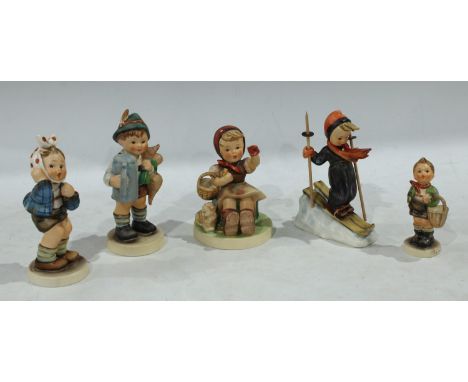 M J Hummel figure of a skier holding a pair of wooden poles; M J Hummel figure 'village boy', holding a basket; M J Hummel fi