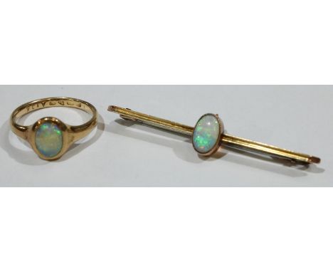 A 9ct gold opal bar brooch; an 18ct gold and opal ring 