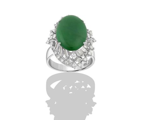 A Jade and Diamond Ringthe oval jade plaque within an undulating border of round brilliant cut and baguette cut diamonds, in 