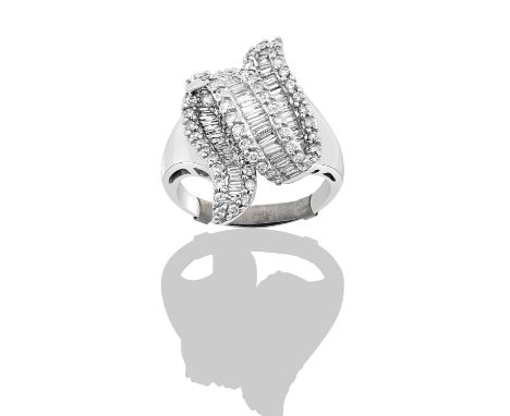 A Diamond Ring the undulating ribbon motif formed of a row of baguette cut diamonds flanked by round brilliant cut diamonds, 