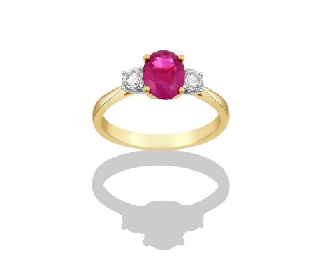 An 18 Carat Gold Synthetic Ruby and Diamond Three Stone Ringthe oval cut synthetic ruby in a yellow claw setting, flanked by 