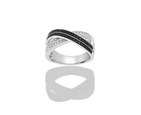 An 18 Carat White Gold Diamond Crossover Ring a double row of black round brilliant cut diamonds crossed by a double row of w