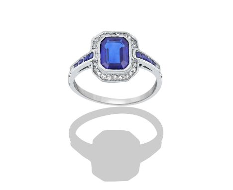 A Sapphire and Diamond Ringthe emerald-cut sapphire within a border of old cut diamonds, in white millegrain settings, to cal