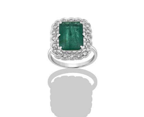 An Emerald and Diamond Cluster Ring, by H.Stern, the emerald-cut emerald within a border of eight-cut diamonds, in white claw