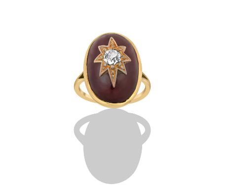 A Victorian Garnet and Diamond Ringthe oval carbuncle garnet in a yellow rubbed over setting, with an old cut diamond central