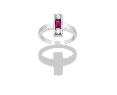 A Ruby and Diamond Three Stone Ringthe rectangular step cut ruby flanked by round brilliant cut diamonds, aligned up the fing