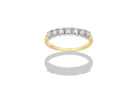 An 18 Carat Gold Diamond Seven Stone Ringthe round brilliant cut diamonds in white claw settings, to a yellow plain polished 