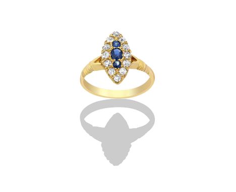 A Sapphire and Diamond Cluster Ringthe navette shaped cluster comprising of an oval cut sapphire flanked by two round cut sap