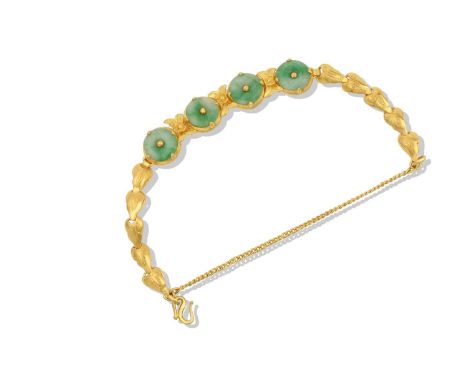 A Jade Bracelet four jade discs with a central yellow bead and in claw settings, spaced by x-motifs, to a fancy link chain le