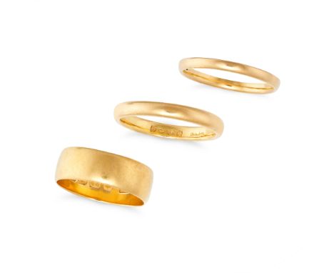 THREE ANTIQUE AND VINTAGE GOLD WEDDING BAND RINGS in 22ct yellow gold, each of plain design, one with full British hallmarks 