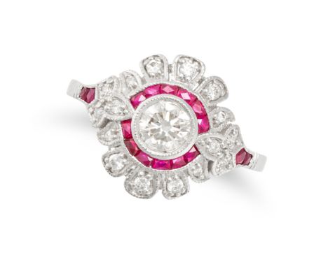 A RUBY AND DIAMOND DRESS RING in 18ct white gold, set with a round brilliant cut diamond in a border of calibre cut rubies, a